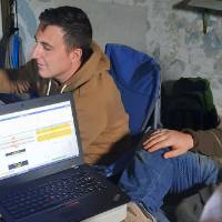 Research team surrounds computer; working on radio